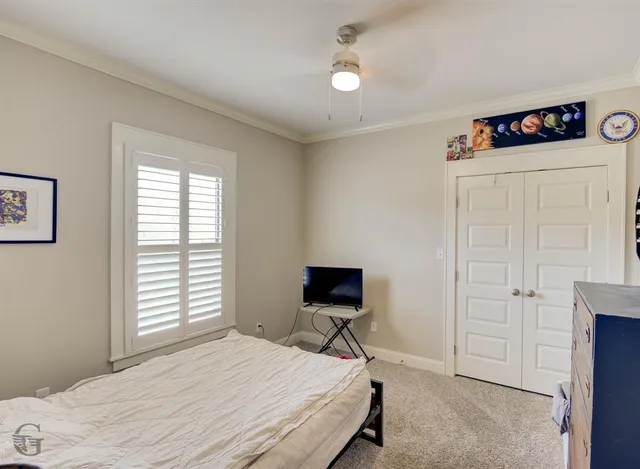 a bedroom with a bed and a television