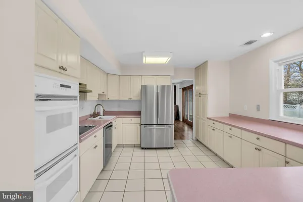 a kitchen with a stove a refrigerator and a sink