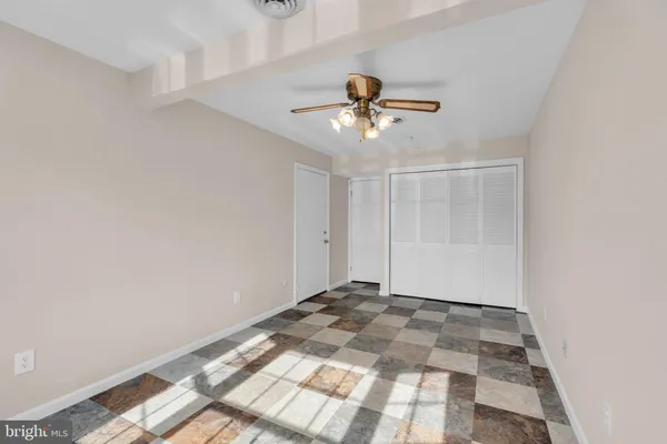a view of room with a ceiling fan and window