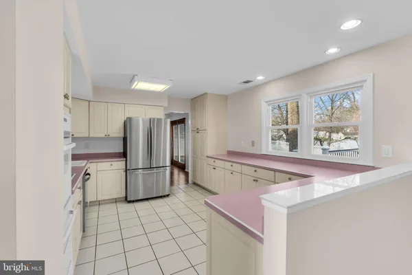 a kitchen with a refrigerator and a stove top oven