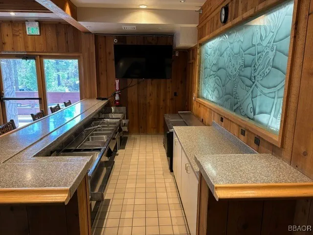 a kitchen with a sink and a large window