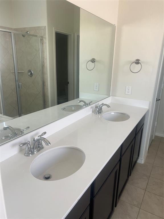1821 Ferguson Lane McKinney, TX 75071 - Photo 15 of 26 a bathroom with a sink and a mirror