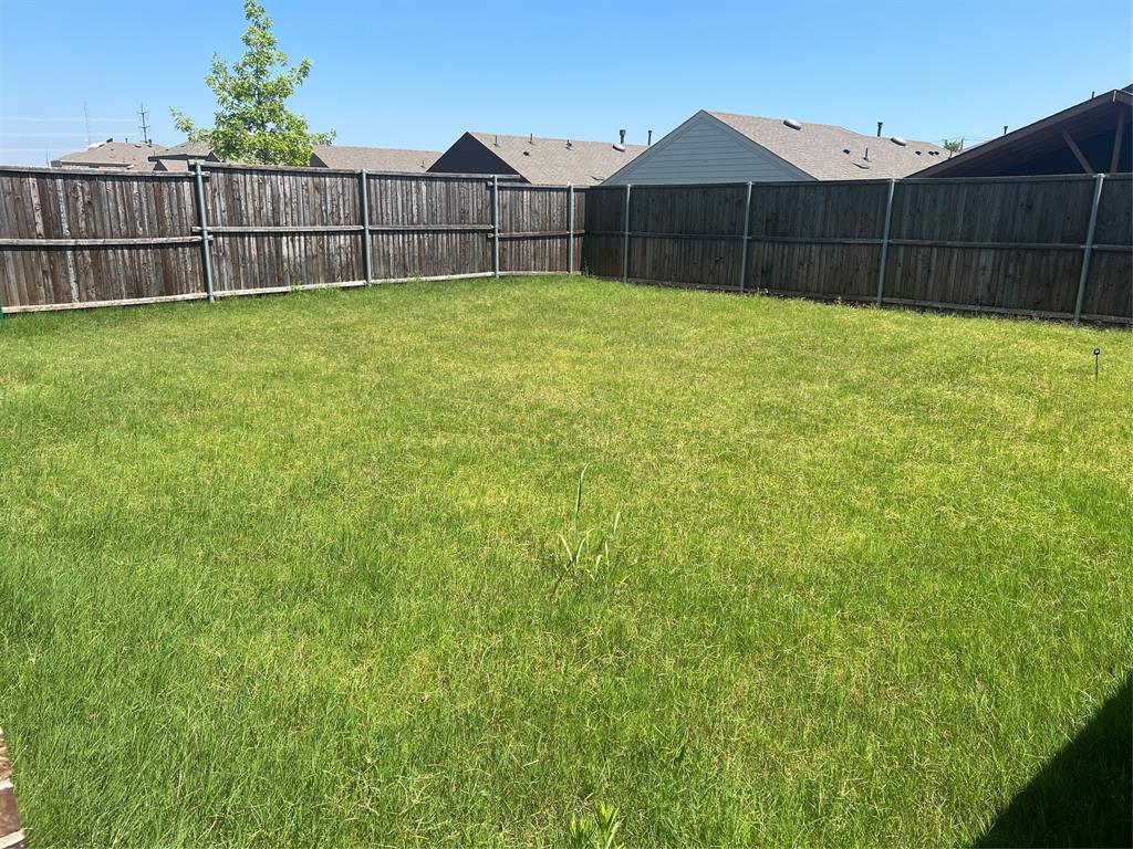 1821 Ferguson Lane McKinney, TX 75071 - Photo 18 of 26 a view of a backyard with wooden fence