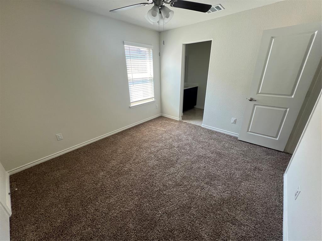 1821 Ferguson Lane McKinney, TX 75071 - Photo 23 of 26 an empty room with windows and fan