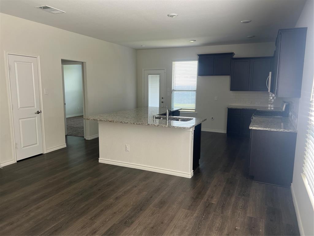 1821 Ferguson Lane McKinney, TX 75071 - Photo 8 of 26 a kitchen with stainless steel appliances granite countertop a refrigerator and a stove top oven