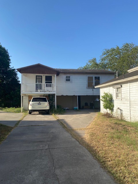 409 Chaparral Street Alice, TX 78332 - Photo 2 of 24 a view of a house with backyard and a car parked in front of it