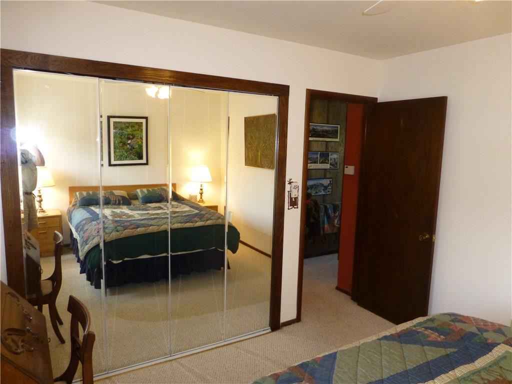 110 Evergreen Road, Unit B303 Dillon, CO 80435 - Photo 17 of 21 a bedroom with a bed and a dresser