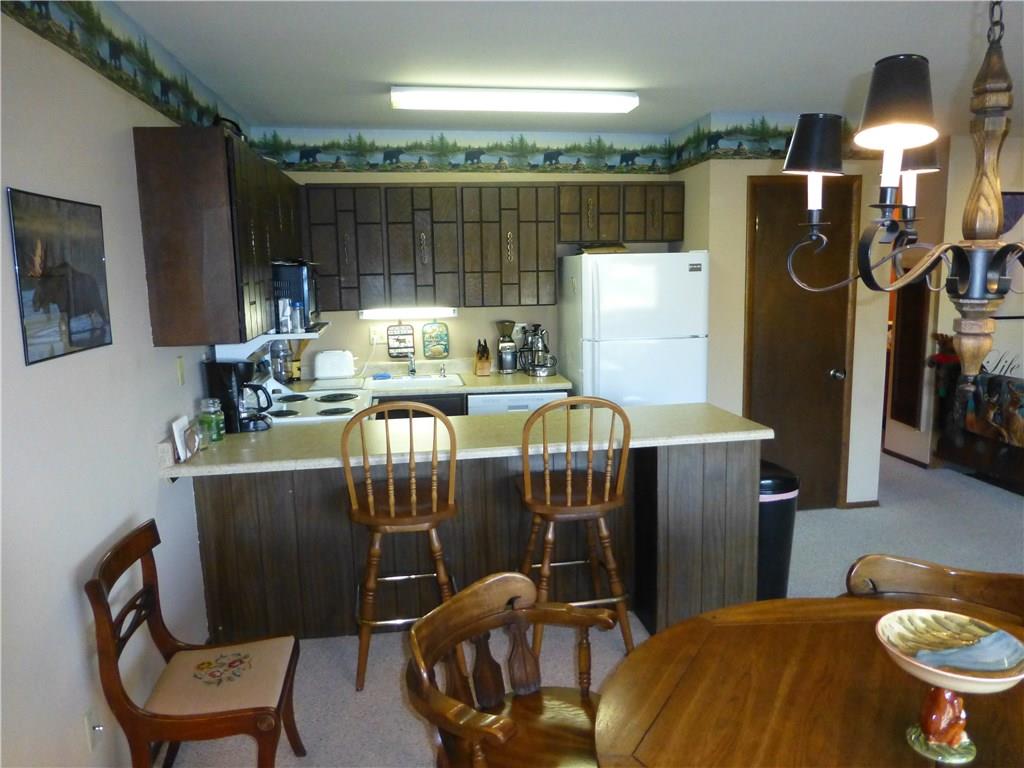 110 Evergreen Road, Unit B303 Dillon, CO 80435 - Photo 18 of 21 a dining room with furniture and lamp