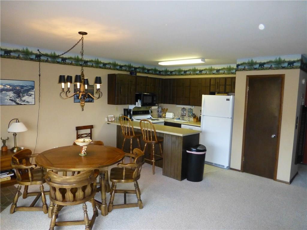 110 Evergreen Road, Unit B303 Dillon, CO 80435 - Photo 9 of 21 a dining room with furniture and a kitchen view