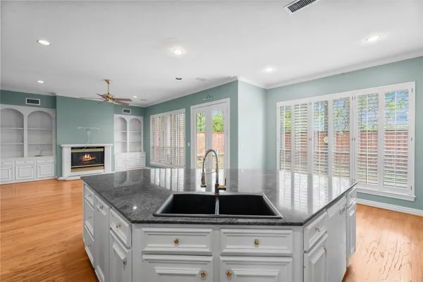 a kitchen with granite countertop a sink and cabinets