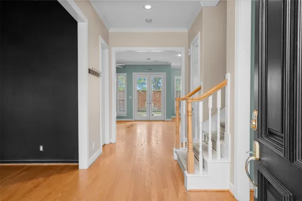 a view of a hallway with wooden floor and staircase