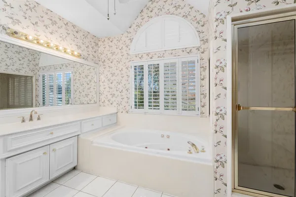 a bathroom with a bathtub sink and mirror