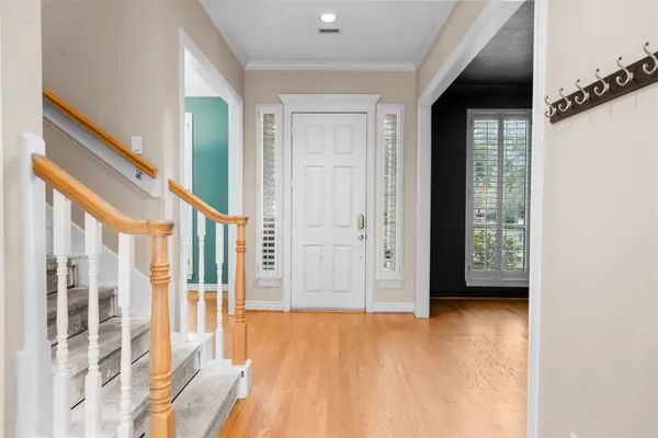 a view of an entryway with wooden floor