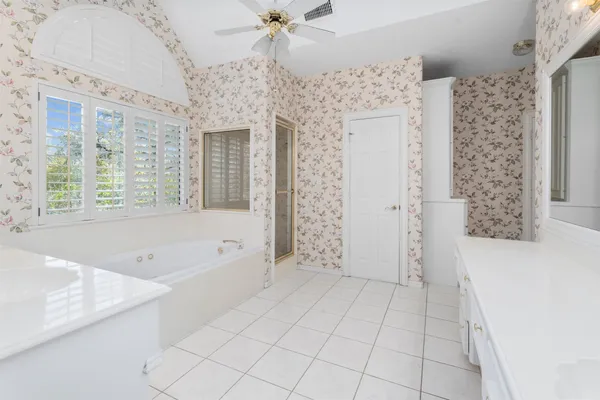 a spacious bathroom with a bathtub and a shower