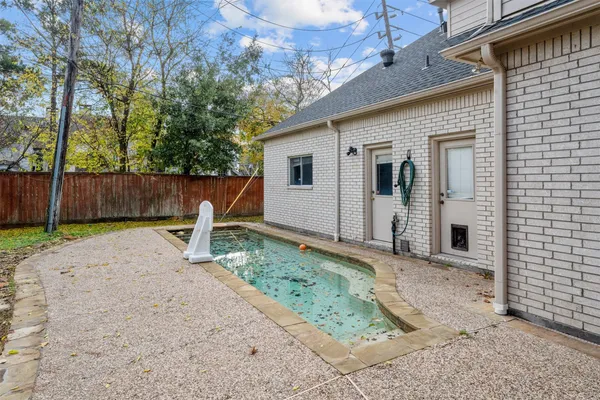 a backyard of a house with table and chairs