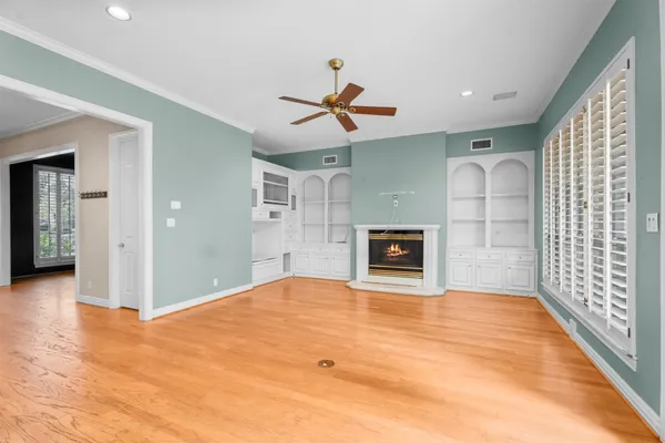 a view of a livingroom with a fireplace and cabinet