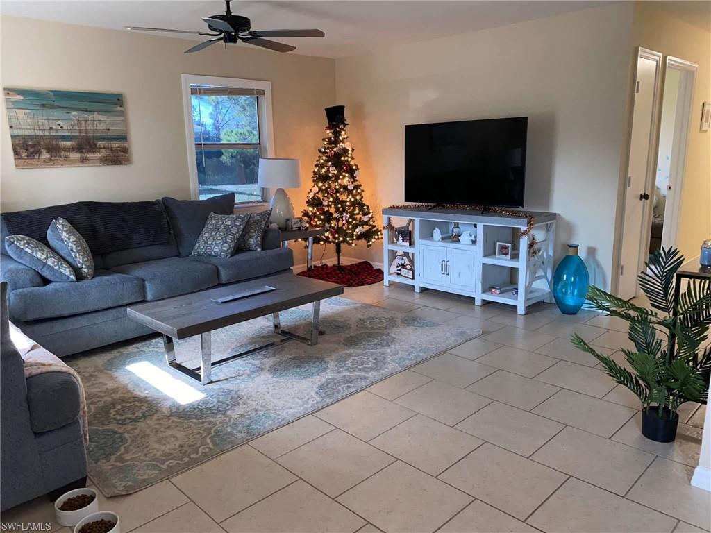 4204 34th Street Southwest Lehigh Acres, FL 33976 - Photo 2 of 8 a living room with furniture and a flat screen tv