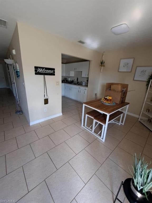 4204 34th Street Southwest Lehigh Acres, FL 33976 - Photo 3 of 8 a room with furniture a rug and white walls