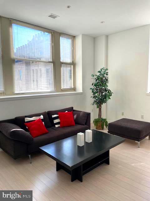 1600 Arch Street, Unit 1904 Philadelphia, PA 19103 - Photo 7 of 21 a living room with furniture and a potted plant