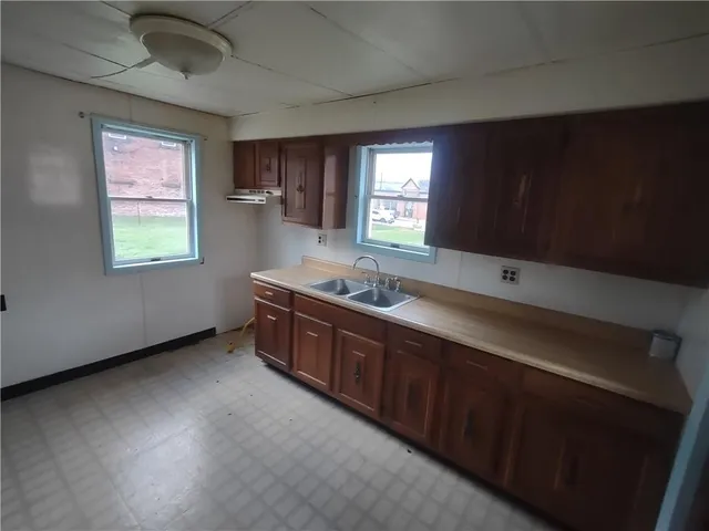 a spacious bathroom with a double vanity sink and a window