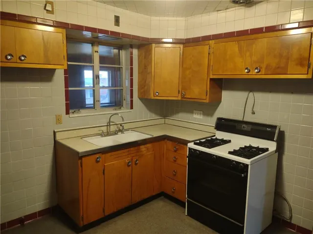 a kitchen that has a sink and a stove