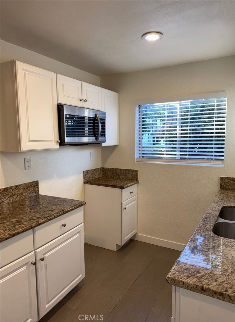 2255 Cahuilla Street, Unit 35 Colton, CA 92324 - Photo 11 of 24 a kitchen with granite countertop a sink and a stove