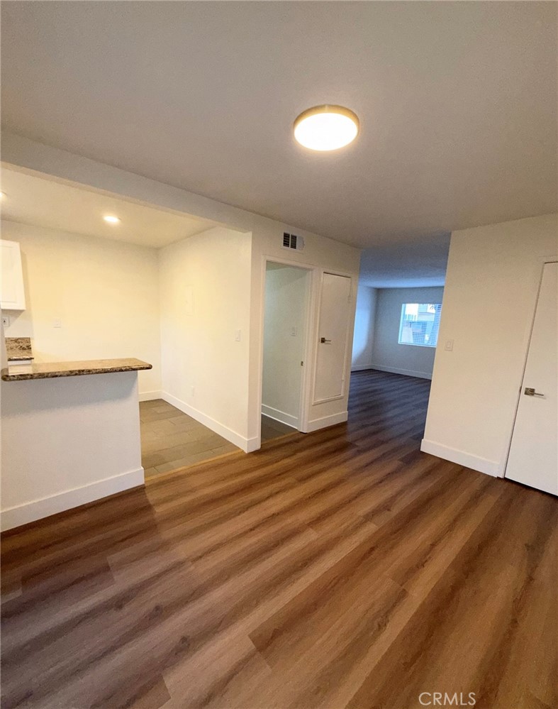 2255 Cahuilla Street, Unit 35 Colton, CA 92324 - Photo 12 of 24 an empty room with wooden floor and entrance