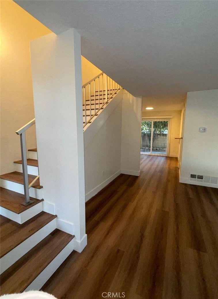 2255 Cahuilla Street, Unit 35 Colton, CA 92324 - Photo 16 of 24 a view of an empty room with wooden floor and a window