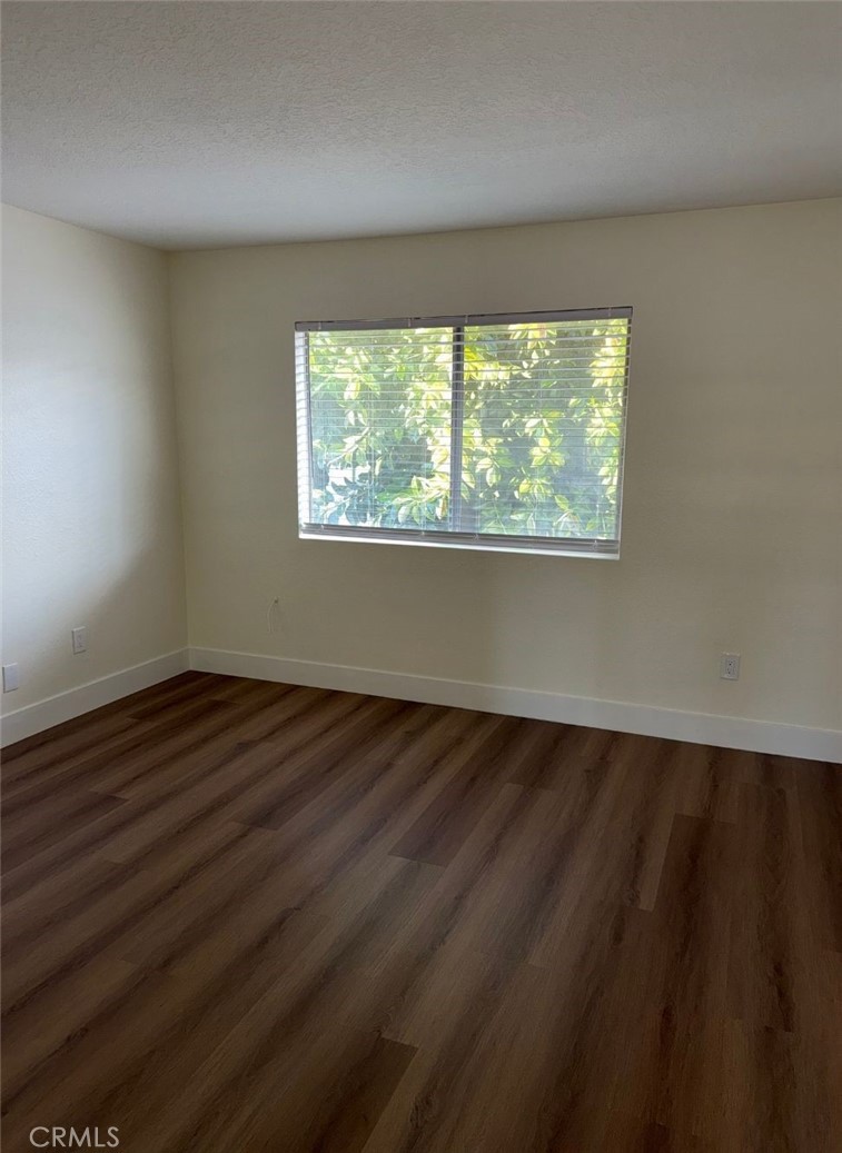 2255 Cahuilla Street, Unit 35 Colton, CA 92324 - Photo 24 of 24 an empty room with wooden floor and windows