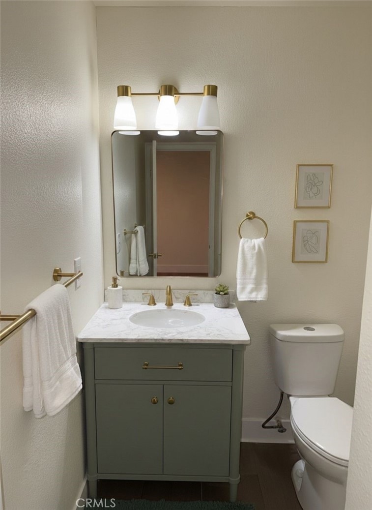 2255 Cahuilla Street, Unit 35 Colton, CA 92324 - Photo 4 of 24 a bathroom with a toilet sink and mirror