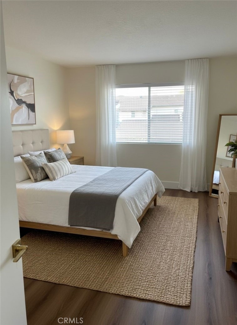 2255 Cahuilla Street, Unit 35 Colton, CA 92324 - Photo 5 of 24 a bedroom with a bed and wooden floor