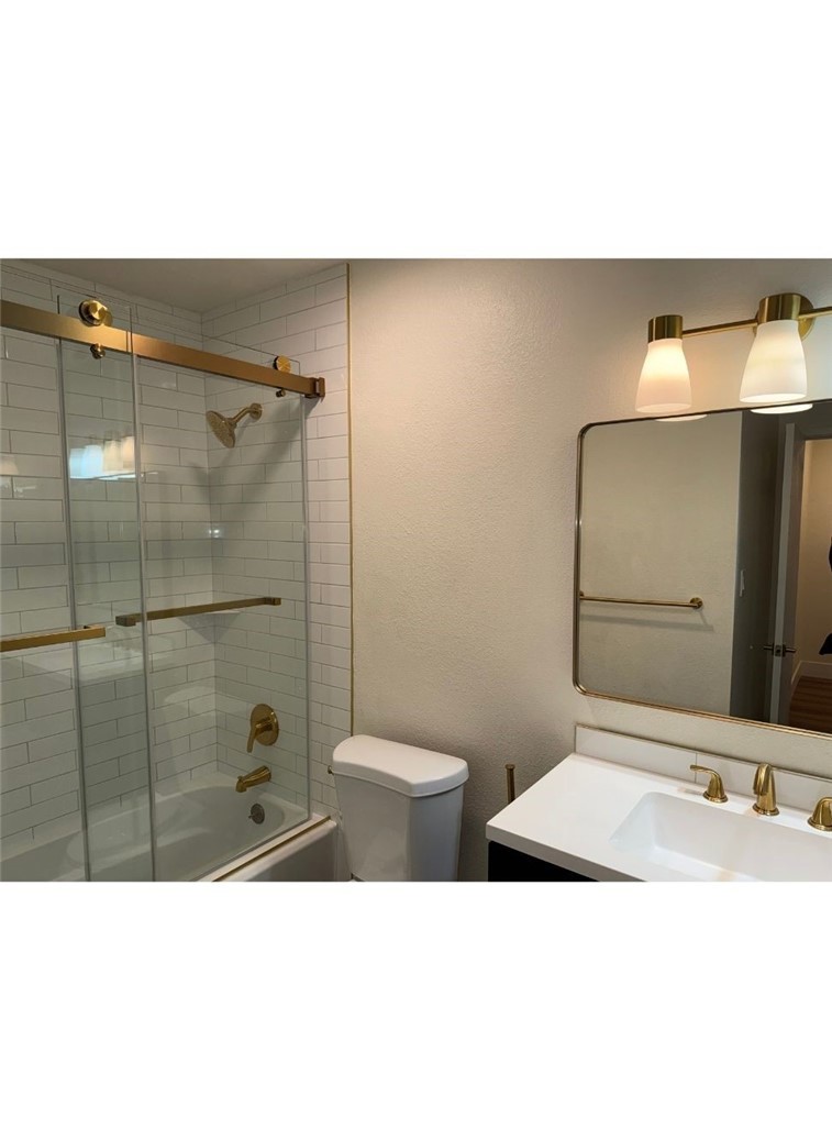 2255 Cahuilla Street, Unit 35 Colton, CA 92324 - Photo 8 of 24 a bathroom with a sink a toilet and shower