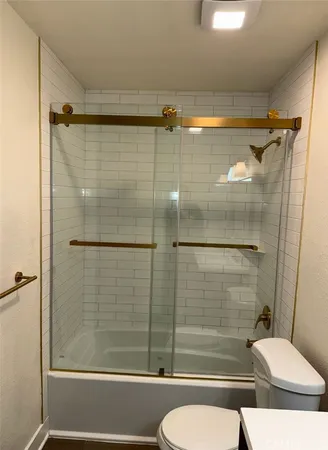 a bathroom with a shower and a toilet