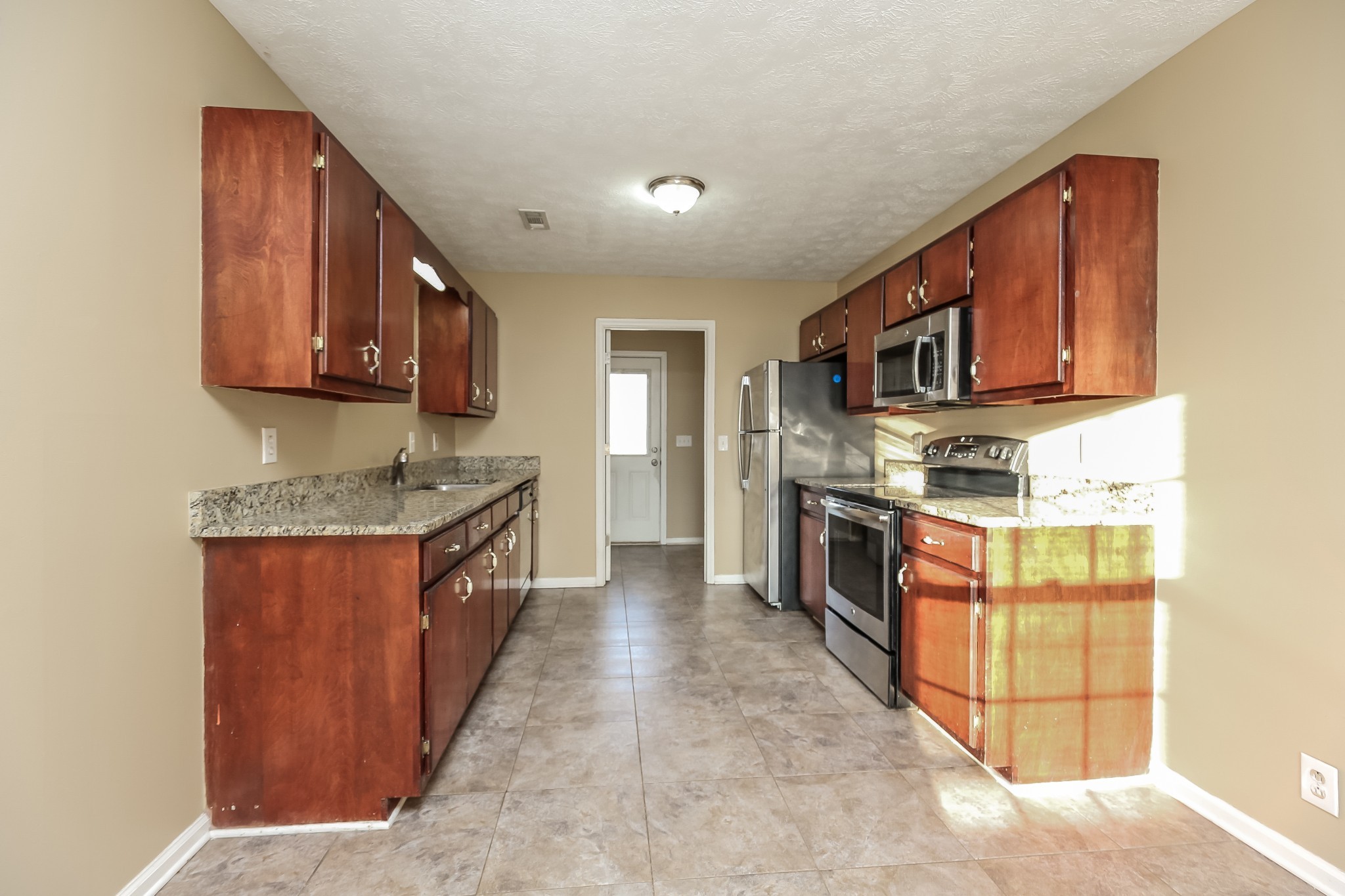 664 Crescent Road Murfreesboro, TN 37128 - Photo 7 of 16 a kitchen with stainless steel appliances granite countertop a stove top oven a sink a counter space and cabinets