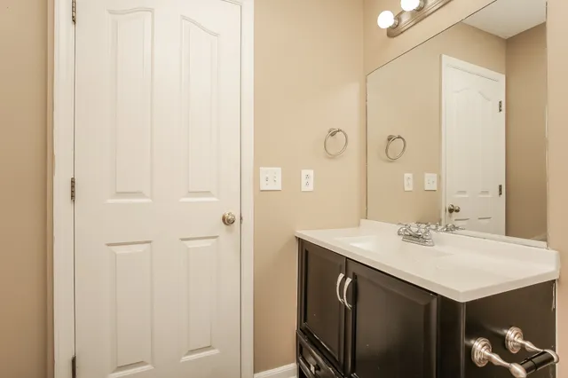 a bathroom with a sink vanity and a mirror