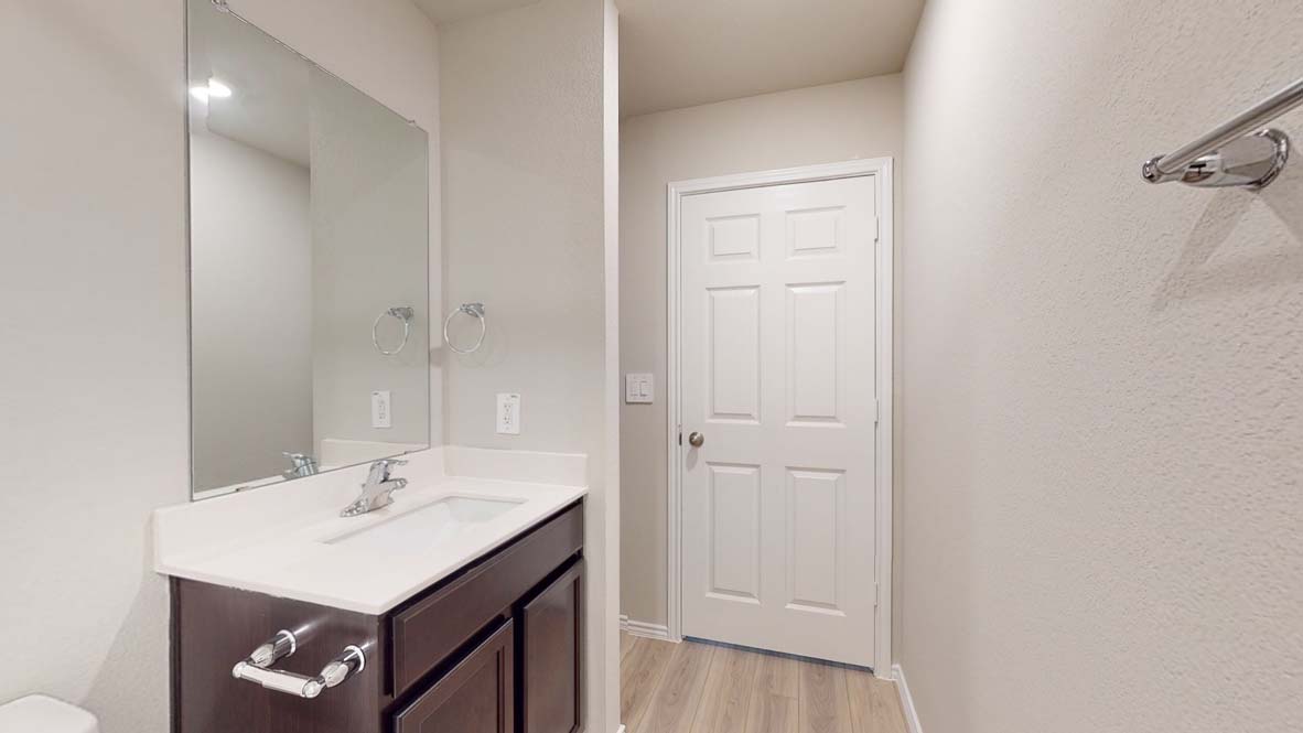 544 Hector Loop Georgetown, TX 78626 - Photo 21 of 22 A well-appointed bathroom with vanity and wood-look flooring awaits.