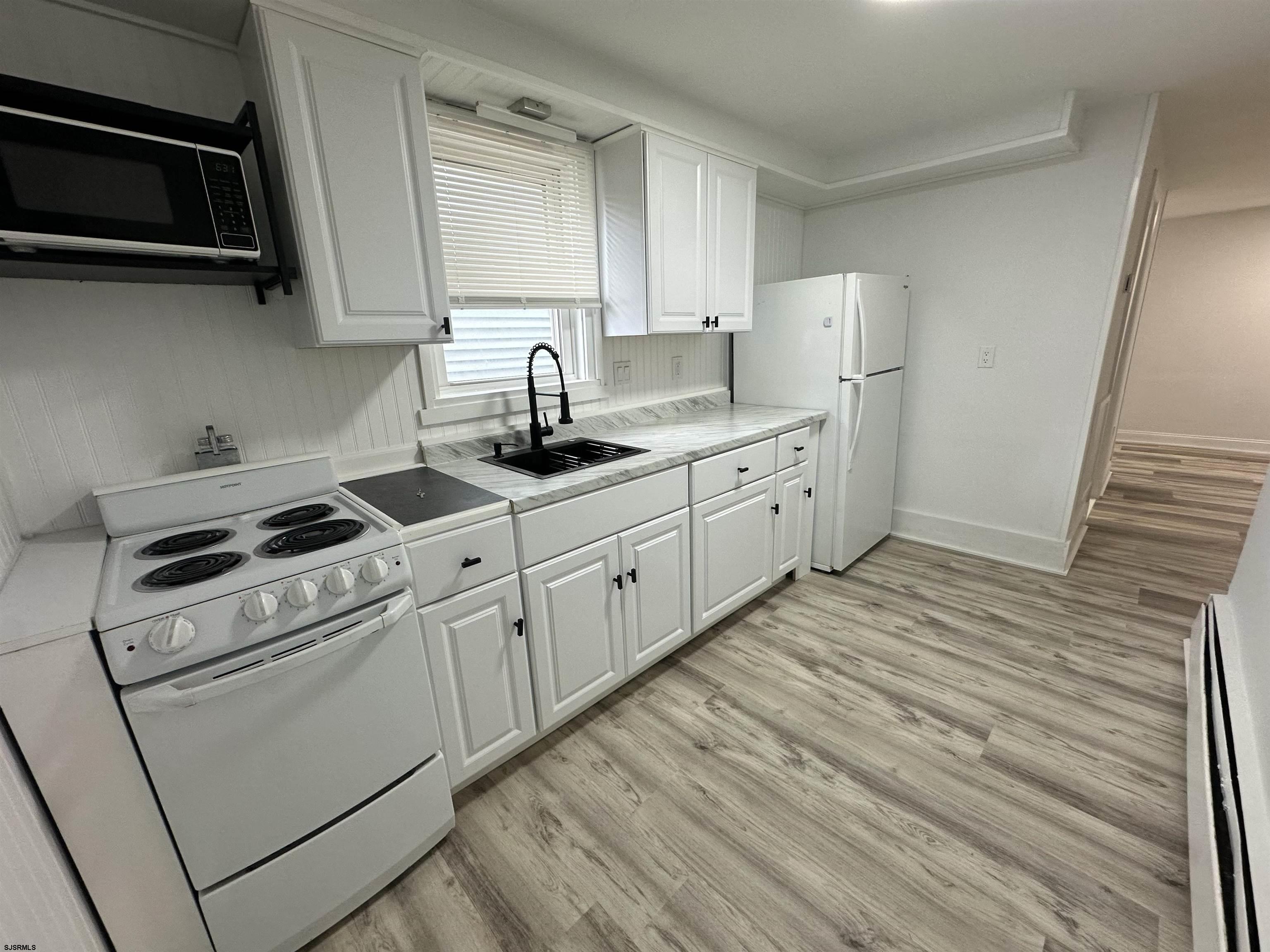 16 South Washington Avenue Margate City, NJ 08402 - Photo 12 of 14 a kitchen with cabinets stainless steel appliances and sink