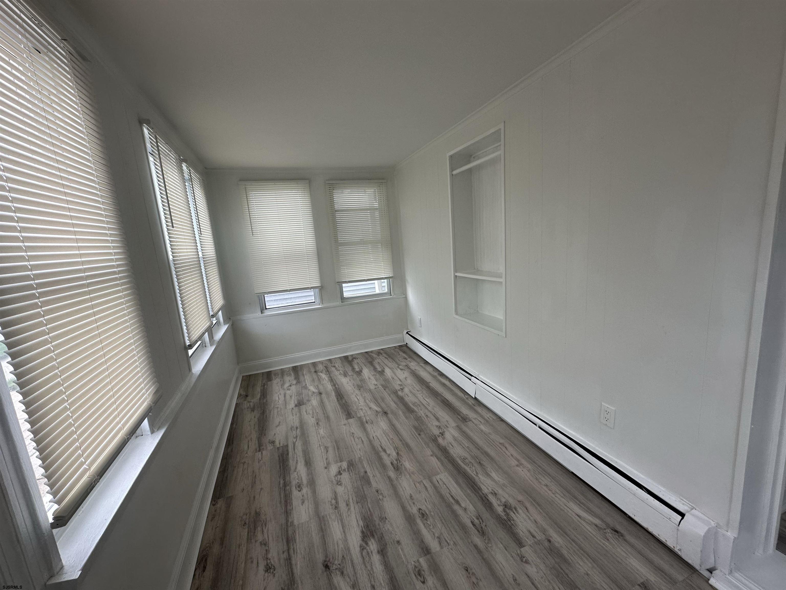 16 South Washington Avenue Margate City, NJ 08402 - Photo 4 of 14 a view of wooden floor in an empty room