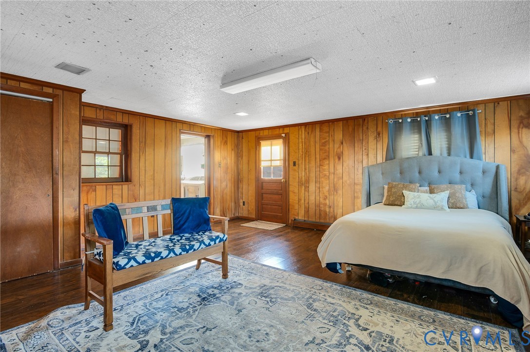 9303 Lawndell Road Henrico, VA 23229 - Photo 14 of 33 a bedroom with a bed and wooden floor