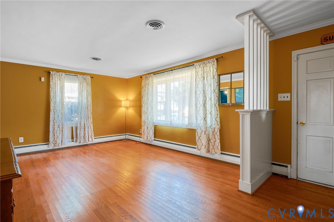 9303 Lawndell Road Henrico, VA 23229 - Photo 4 of 33 a view of an empty room with wooden floor and a window