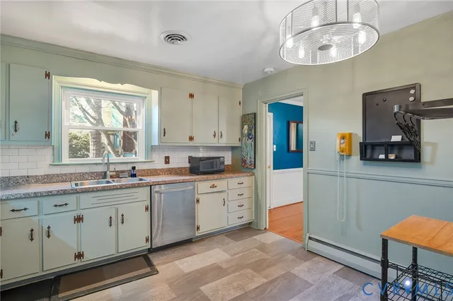 a large kitchen with stainless steel appliances granite countertop a sink and cabinets
