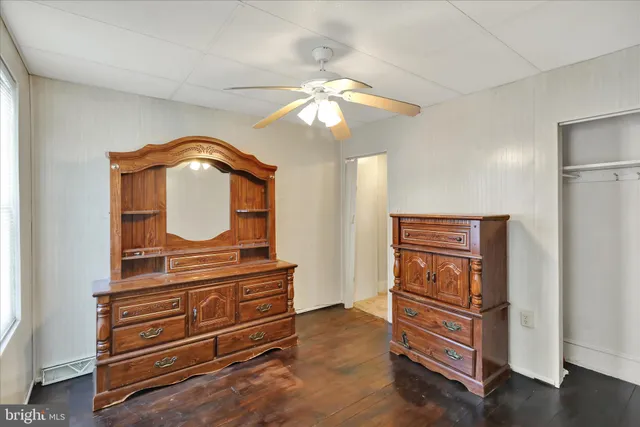 a view of a room with wooden floor and windows