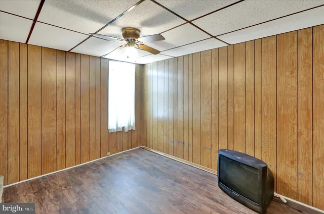 a view of a room with wooden walls