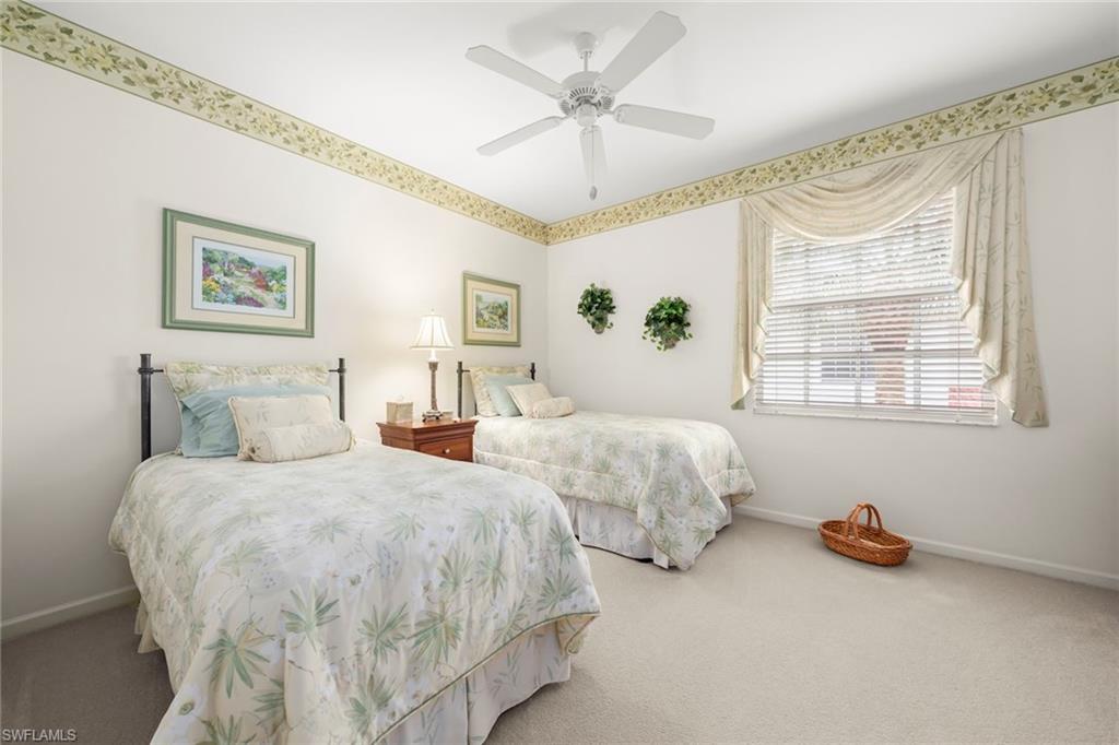 23101 Rosedale Drive, Unit 202 Estero, FL 34135 - Photo 11 of 49 a bedroom with two beds and painting on the wall