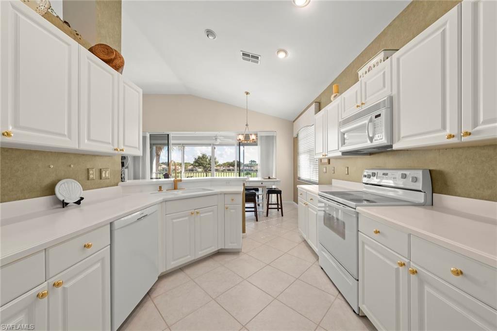 23101 Rosedale Drive, Unit 202 Estero, FL 34135 - Photo 12 of 49 a kitchen with cabinets appliances and a window