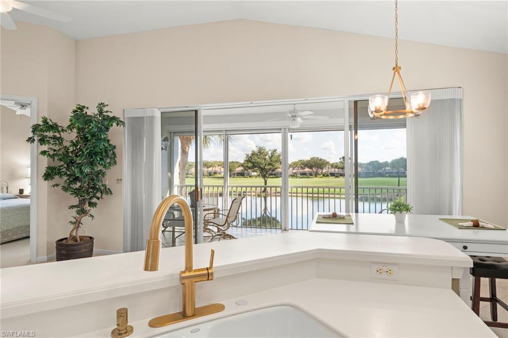 23101 Rosedale Drive, Unit 202 Estero, FL 34135 - Photo 13 of 49 a living room with hardwood floor and a floor to ceiling window