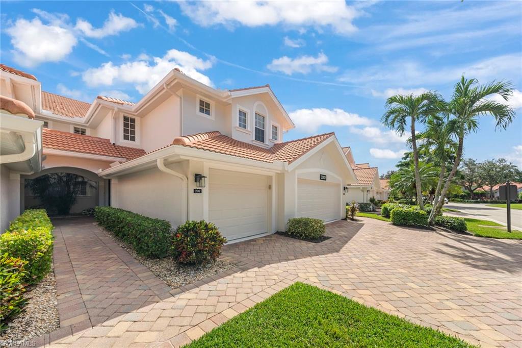 23101 Rosedale Drive, Unit 202 Estero, FL 34135 - Photo 16 of 49 a front view of a house with garden