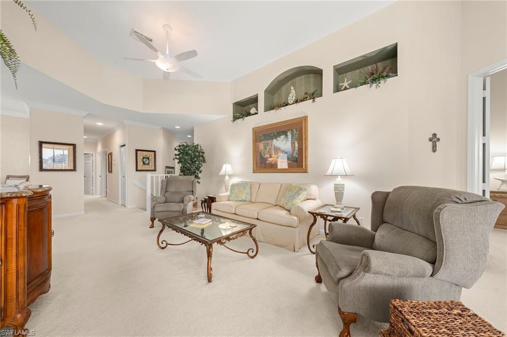 23101 Rosedale Drive, Unit 202 Estero, FL 34135 - Photo 18 of 49 a living room with furniture and a potted plant