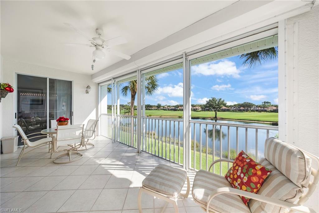23101 Rosedale Drive, Unit 202 Estero, FL 34135 - Photo 2 of 49 a living room with furniture and a floor to ceiling window
