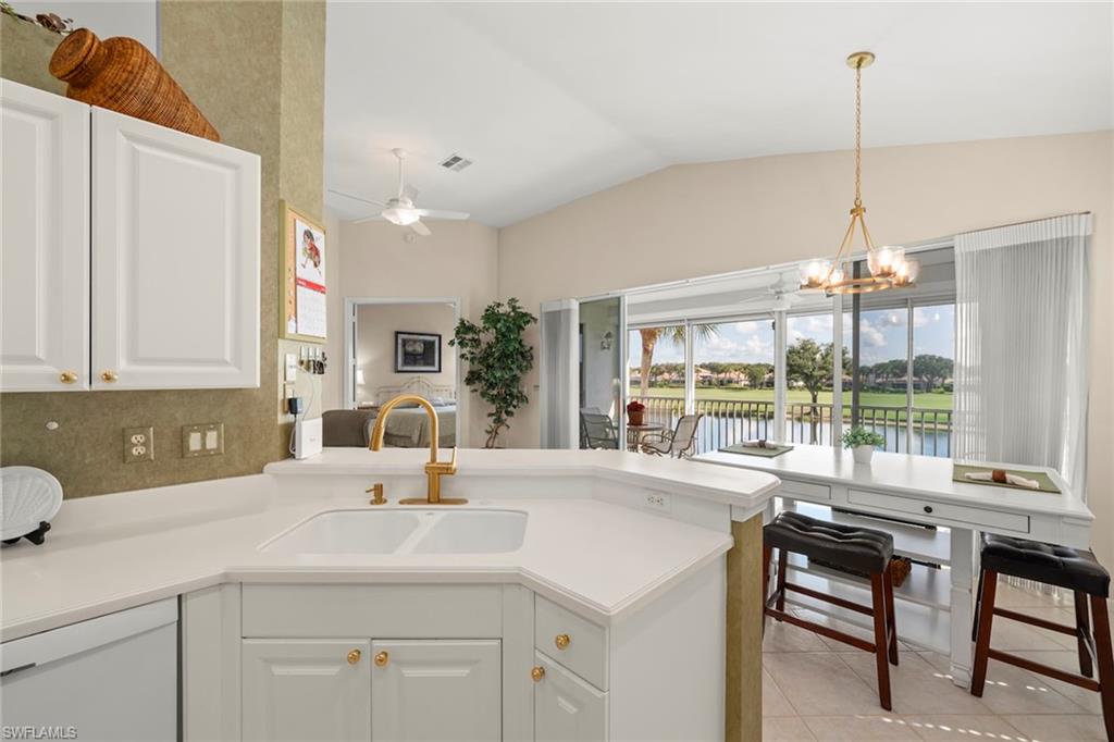 23101 Rosedale Drive, Unit 202 Estero, FL 34135 - Photo 23 of 49 a kitchen with a sink a large window and chairs